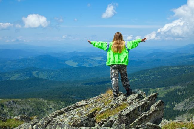 woman-standing-at-top-rock_resized